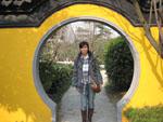 Sonya standing in a brightly coloured arch