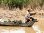 Man paddling wooden boat