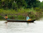 Mother and daughter on wooden canoe
