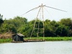 Fishing boats with large nets that pickup fish that have swum over the nets