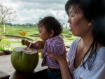 Farah enjoying a coconut, more so the flower