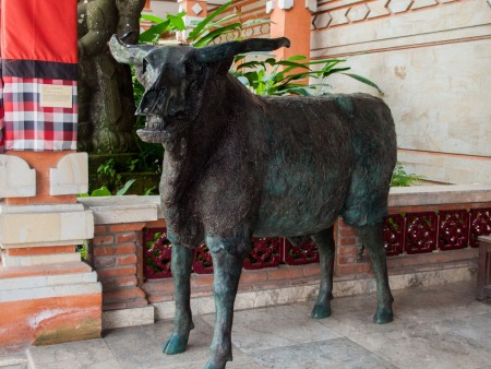 Scary metal bull statue with exposed skull