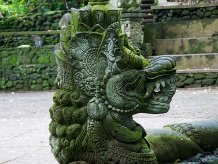 Ancient intricately carved stone with moss growing