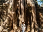 Sonya standing next to the roots of a large tree