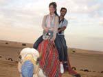 Sonya and Travis riding a camel