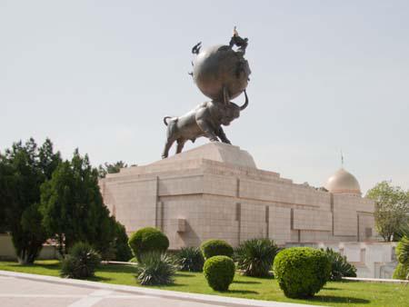 Earthquake memorial, a bull with a globe and a women holding a child