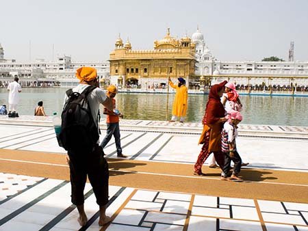 Travis taking a photo of a Sikh at the Golden Temple