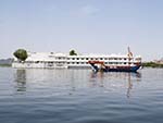 Jag Niwas Lake Palace with a traditional wooden boat