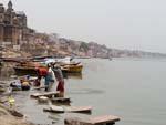 Men thrashing cloths on stones in the Ganges River