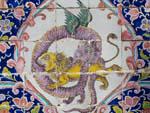 Colourful painted tiles featuring a dragon and lion fighting