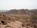 Kharanaq mud brick village with the turquoise mosque dome visible in the background