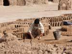 A man creating mud bricks, used to restore Narin Castle