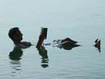 Dead Sea - Travis reading the Lonely Planet in the Dead Sea