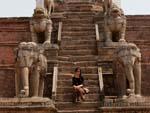 Sonya at Fasidega Temple flanked by elephant guardians at the bottom of the steps and lions and cows above