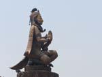 The man-bird Garuda with the similar looking King Yoganarendra Malla statue in the background
