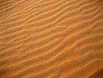 Patterns in the sand caused by wind erosion