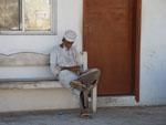 Omani sitting on a bench near to the  Fish Market