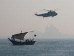 Modern military helicopter with tradition dhow