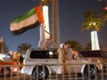 UAE flag standing on car