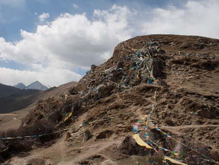 A spider web of prayer flags on the hill